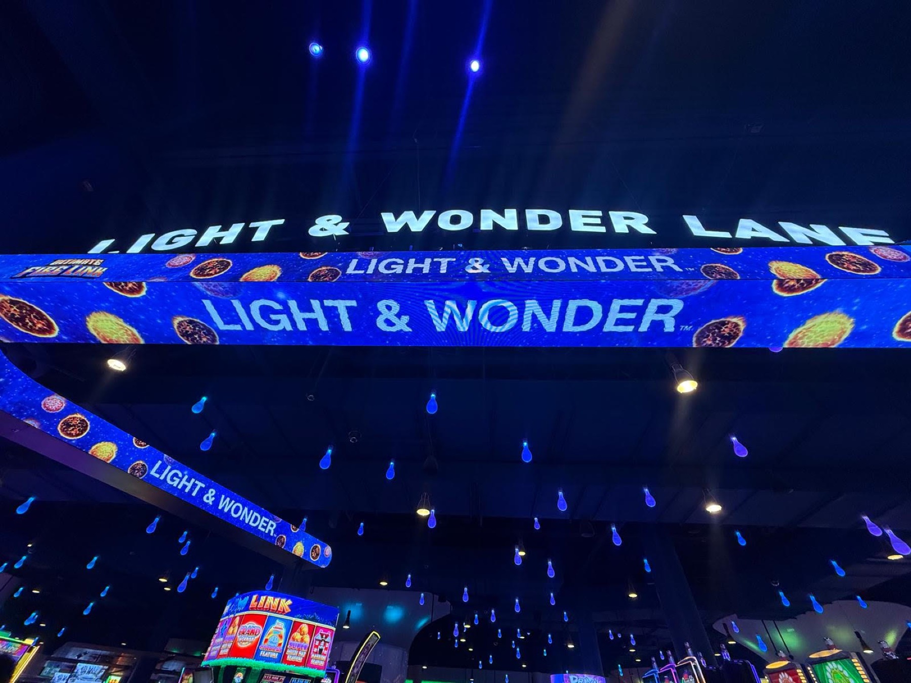 The banner in blue, the Light & Wonder name repeating along the ribbon
