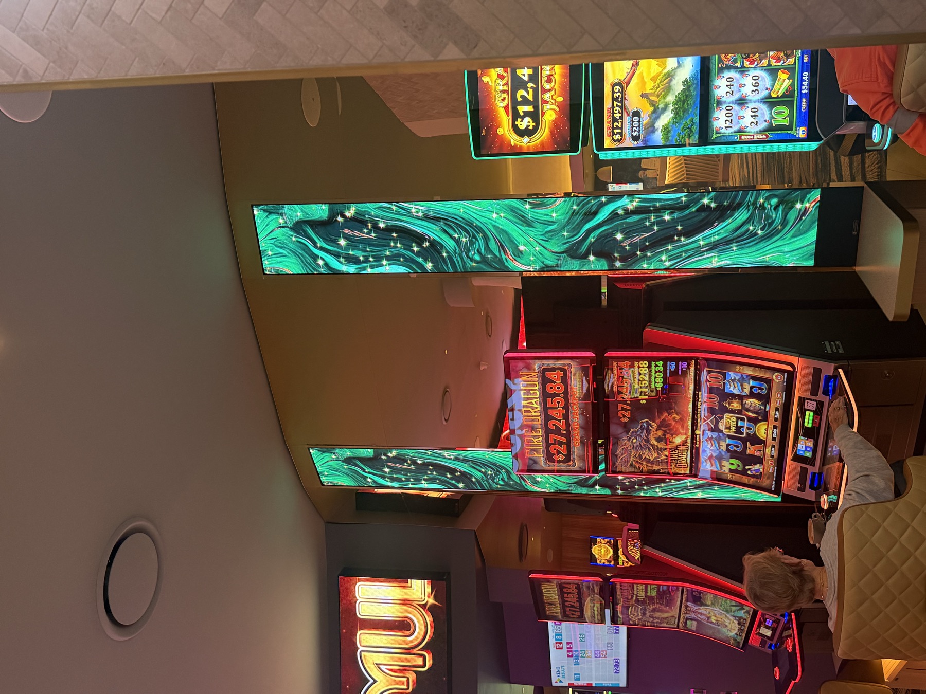 Two tall portrait LED columns in swirling teal marble beside the machines